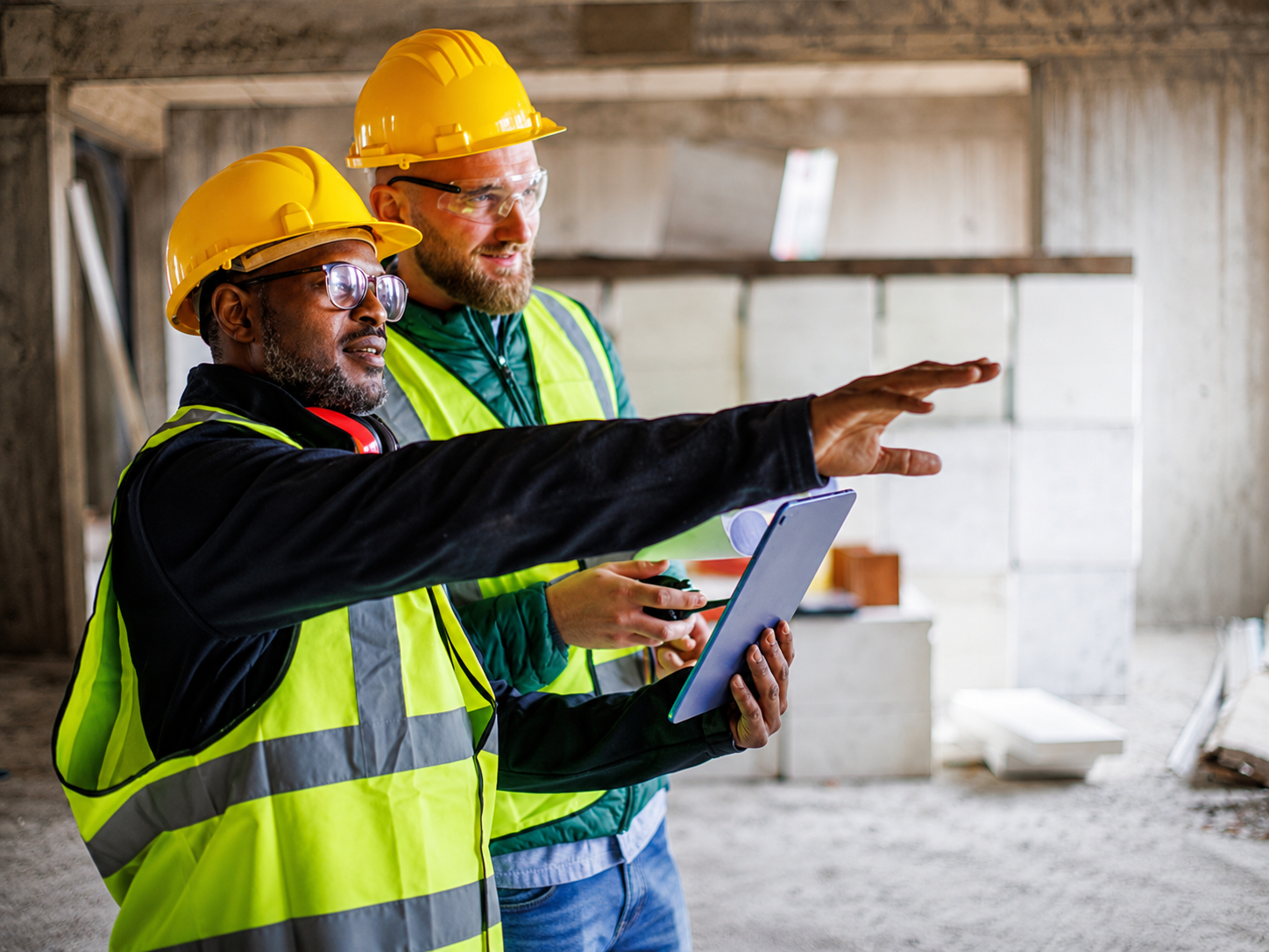 Construction managers coordinating work inside an active building